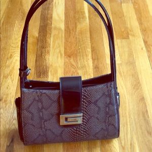 Guess brand snake print patent hand bag.